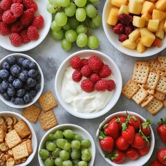 Wall Mural - A variety of snacks in white bowls, including yogurt with raspberries, blueberries, grapes, strawberries, and crackers.