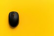 © volga - Black wireless mouse on yellow background