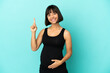 © luismolinero - Woman over isolated background pregnant and pointing up