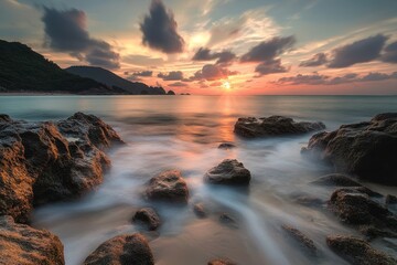 Wall Mural - Golden Sunset over Rocky Coastline - A breathtaking sunset with golden light illuminating the rocky coastline and soft waves gently flowing over the shore.