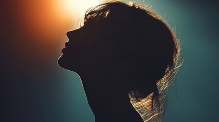 Poster - A woman's silhouette is shown against a blue sky. Concept of loneliness and introspection, as the woman's face is not visible