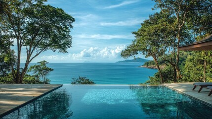 Wall Mural - Infinity pool overlooking a tropical ocean.