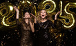 © ty - Happy gorgeous girls in stylish sexy party dresses holding gold 2025 balloons, having fun at New Year's Eve Party.