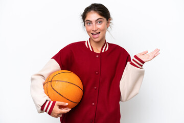 Young basketball player woman isolated on white background with shocked facial expression