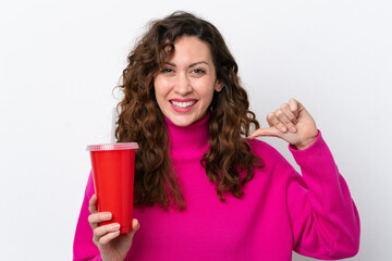 Wall Mural - Young caucasian woman drinking soda isolated on white background proud and self-satisfied