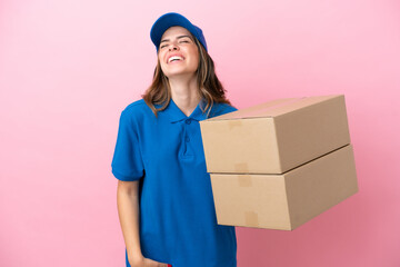 Wall Mural - Delivery Italian woman isolated on pink background laughing