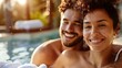 © Galib - A couple smiles together while enjoying the pool.