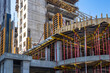 © Grispb - Construction site. Erection of city block. Building under construction with metal struts. Erection building for indoor flogging. Skyscrapers under construction with blue sky. Architectural industry