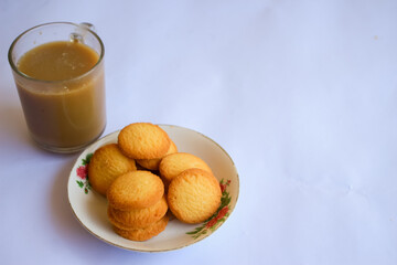 breakfast menu in the form of Danish butter cake and a glass of chocolate milk, Close up of butter cookies coated with white sugar and a glass of chocolate, sweet cake