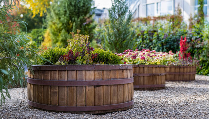 Beautiful green garden with wooden barrel planters and variety of plants. Landscape design.