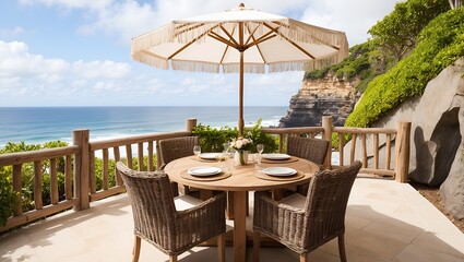 outdoor dining setup on a cliffside terrace overlooking the ocean.