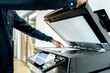 © A Stockphoto - Hand use copier or photocopier or photocopy machine office equipment workplace for scanner or scanning document or printer for printing paperwork hard copy duplicate Xerox service maintenance repair.