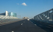 © Grispb - Expressway under blue sky. Highway in modern city. Three-lane new road. Highway with soundproof shields. Modern bridge in sunny metropolis. Expressway near high-rise residential buildings