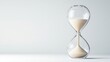 © Gyorgy - Minimalist hourglass, with a few grains of sand emphasizing the passage of time, 3D illustration