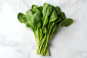 Wall Mural - A fresh bunch of spinach on a marble surface, ideal for cooking or salads.