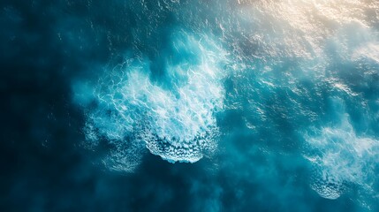 Wall Mural - Aerial view of swirling ocean waves and currents, creating a dynamic and textured pattern of blue water and white foam.