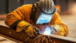 © Piya W. - Steel beam welding, worker in fire-resistant gear, flat design illustration