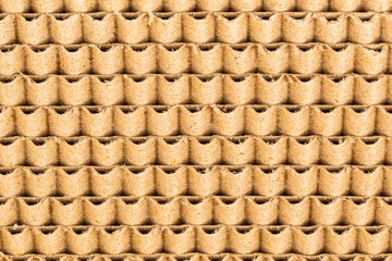 Closeup view of pattern of corrugated cardboard design as a post for cat scratching, background.