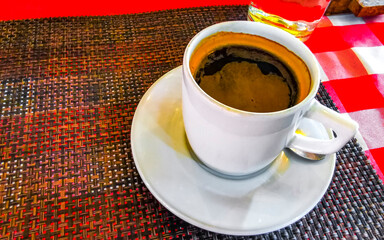 Cup of americano black coffee in restaurant cafe in Mexico.