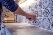 © Hafiz - Installing a new kitchen backsplash,  lifestyle photography, with copy space