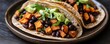 © Aromdee - Delicious tacos filled with black beans and sweet potatoes topped with fresh herbs and avocado, perfect for a healthy meal.