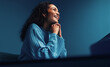 © Jacob Lund - Businesswoman listening in a meeting, blue colorful studio shot