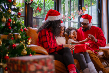 Wall Mural - Family decorate Christmas tree at home.