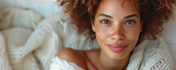 Wall Mural - A woman enjoying a peaceful moment, sitting alone with a cup of tea and a contemplative expression against a white backdrop.