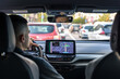 © puhimec - Man touching screen of a GPS navigation system in his car.