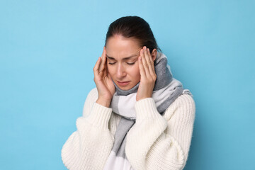 Canvas Print - Sick woman suffering from cold symptoms on light blue background