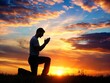 © Shafiqul - A young man in a praying pose set against a vibrant sunset sunrise sky on his Knees Also related to sacrifice, sanctification, shepherd, trinity, shadow