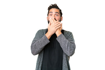 Young man with beard over isolated chroma key background covering mouth with hands