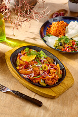 Wall Mural - Delicious Pork Fajitas with Vegetables on a Sizzling Plate