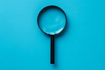 A magnifying glass is on a blue background. The blue background is a very calming color, and the magnifying glass is a symbol of curiosity and exploration