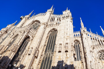 Magnificent Milan Cathedral. Gothic architecture and towering spires against a clear sky. Duomo di Milano in Italy, Dedicated to Santa Maria Nascente