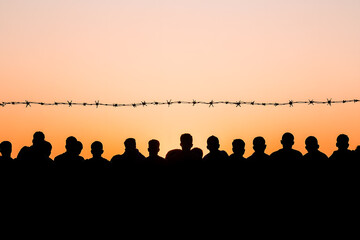 Wall Mural - Silhouette of a Crowd of Refugees or Illegal Immigrants | Migration Crisis and Humanitarian Struggle