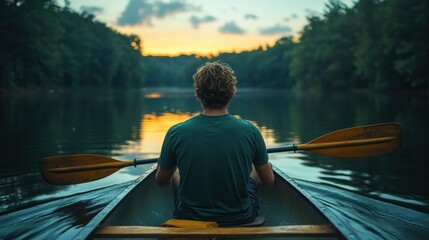  Close-Up of a Young Man in a Green T-Shirt Canoeing on a Lake at Dusk, Rowing with Oars and Gazing at the Forest Landscape Under a Starry Sky Reflected on the Water