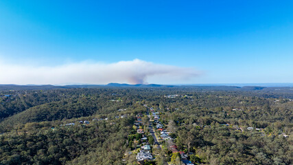 Drone aerial photograph of smoke in the distance from controlled hazard reduction burning in the Blue Mountains in New South Wales, Australia.