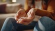 © masyastadnikova - Close up of woman's hand showing a few pills, emphasizing the importance of medication in her daily routine.
