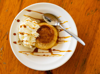 Creamy flan served with toppings on plate for dessert