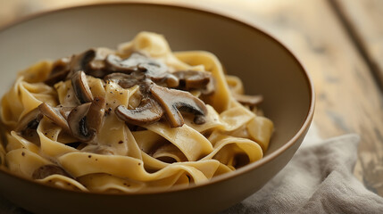 pappardelle with wild mushroom sauce with a creamy sauce and sautã©ed mushrooms against an isolated warm-toned background