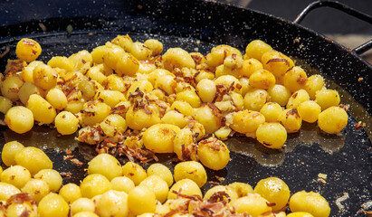 Golden, crispy roasted potatoes in a skillet, herbs, garlic, savory dish, homemade food, delicious, appetizing, culinary, gourmet, fried, cooking concept