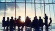 © Felippe Lopes - Silhouettes of business people in a meeting room overlooking the city at sunset.
