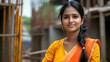 © Siasart Stock - A confident woman in traditional attire poses at a construction site.