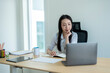 © Wasana - Young asian businesswoman working from home office using laptop computer