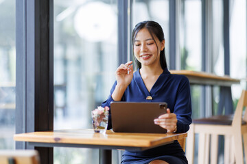 Wall Mural - Business asian woman freelancer using tablet with blank screen for design mockup device Tablet with blank screen for design mockup
