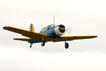 Classic American war bird. World War 2 aircraft, well maintained flying b with radial engine and tail wheel.  Vintage military aircraft in blue and yellow