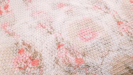 background, wallpaper or texture of crumpled white fabric with floral pattern