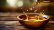 © Kraiwit - Drops of golden oil splashing into a wooden bowl, highlighting its natural purity and smooth texture in an earthy