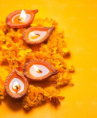 Diwali diya oil lamps with flowers holiday background. Creating a festive and decorative composition.